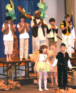 young drama club students performing on stage