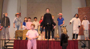 young drama club students performing on stage